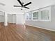 Bright living room featuring hardwood floors, large windows, and a modern ceiling fan at 5225 20Th N St, St Petersburg, FL 33714