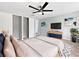 Comfortable main bedroom with a ceiling fan, walk-in closets, and a dresser with a television at 5225 20Th N St, St Petersburg, FL 33714
