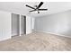 Comfortable main bedroom with carpeted floors, a ceiling fan, and walk-in closets at 5225 20Th N St, St Petersburg, FL 33714