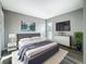 Serene bedroom featuring soft gray tones, a comfortable bed, and a bright window at 6100 12Th S St # 313, St Petersburg, FL 33705