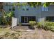 Backyard with privacy fence and a view of the house with a screened-in porch at 6703 Citrus Creek Ln, Tampa, FL 33625