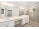 Spacious bathroom with double sinks, a large mirror, and a glass-enclosed shower at 6703 Citrus Creek Ln, Tampa, FL 33625