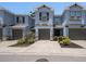 Charming two-story townhome with blue exterior, brown trim, attached garage, and landscaped yard at 6703 Citrus Creek Ln, Tampa, FL 33625