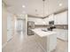 Beautiful kitchen featuring stainless steel appliances, a large island and modern white cabinetry at 6703 Citrus Creek Ln, Tampa, FL 33625