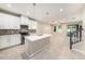 Bright, open kitchen with white cabinets, an island with pendant lights and stainless steel appliances at 6703 Citrus Creek Ln, Tampa, FL 33625