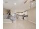 Spacious living room with tile floors, access to the kitchen, and stairs to the second floor at 6703 Citrus Creek Ln, Tampa, FL 33625