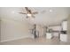 Open concept living room featuring tile flooring, a ceiling fan, and open access to the kitchen at 6703 Citrus Creek Ln, Tampa, FL 33625