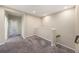 Carpeted upstairs loft area with neutral paint, stairs to the lower level, and hallway entrance at 6703 Citrus Creek Ln, Tampa, FL 33625