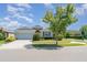 Charming single-story home with manicured lawn and two-car garage on a sunny corner lot at 7308 Hermes Ct, Apollo Beach, FL 33572