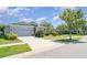 Inviting single-story home with a well-maintained lawn, sunny skies, and a spacious driveway at 7308 Hermes Ct, Apollo Beach, FL 33572