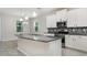 Bright kitchen with granite countertops, stainless steel appliances, mosaic backsplash, and abundant storage at 7308 Hermes Ct, Apollo Beach, FL 33572