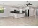 Spacious, open-concept living area with tile floors, abundant natural light, and view to the kitchen at 7308 Hermes Ct, Apollo Beach, FL 33572