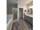 Luxurious bathroom with a soaking tub, walk-in shower, dual vanities, and modern fixtures at 1212 Georgia Trace Ave, Valrico, FL 33596