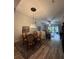Open-concept dining room boasts an ornate light fixture and seamless transition to the living area at 1212 Georgia Trace Ave, Valrico, FL 33596