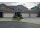 Stylish townhome featuring a three-car garage, well-maintained landscaping, and a welcoming exterior design at 1212 Georgia Trace Ave, Valrico, FL 33596