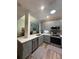 Well-designed kitchen with a breakfast bar, gray cabinets, stainless steel appliances, and open access to dining at 1212 Georgia Trace Ave, Valrico, FL 33596