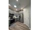 Modern kitchen featuring gray cabinets, stainless steel appliances, and a bright, airy design with a skylight at 1212 Georgia Trace Ave, Valrico, FL 33596