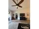 Bright living room with a vaulted ceiling, sliding glass doors, and view of the adjoining bedroom at 1212 Georgia Trace Ave, Valrico, FL 33596