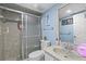 Bathroom featuring single vanity with marble style countertop and a glass enclosed shower at 14506 Sutter Pl, Tampa, FL 33625