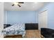 Bedroom featuring a bed with Paris themed bedding, a ceiling fan, and dresser at 14506 Sutter Pl, Tampa, FL 33625
