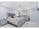 Bright bedroom with a Paris themed bedding, light colored walls, and tile flooring at 14506 Sutter Pl, Tampa, FL 33625