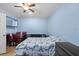Bedroom with a TV on the wall, ceiling fan, and bed with Paris themed bedding at 14506 Sutter Pl, Tampa, FL 33625