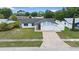 Charming single-story home boasting a well-manicured lawn, two car garage, and appealing architectural detail at 14506 Sutter Pl, Tampa, FL 33625