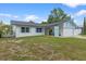 Charming single-story home with a well-maintained lawn, light blue shutters, and an attached two-car garage at 14506 Sutter Pl, Tampa, FL 33625