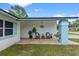 Cozy covered front porch featuring a seating area with wicker chairs and a lovely outdoor space at 14506 Sutter Pl, Tampa, FL 33625