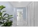 Bright hallway featuring modern finishes, closet space, and a glimpse into the open kitchen and dining area at 14506 Sutter Pl, Tampa, FL 33625