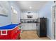 Compact kitchenette features white cabinets, appliances, and ample counter space inside a well-lit room at 14506 Sutter Pl, Tampa, FL 33625