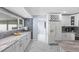 A well-lit kitchen featuring a breakfast bar, modern appliances, beautiful countertops, and tiled backsplash at 14506 Sutter Pl, Tampa, FL 33625