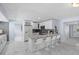 Bright kitchen with marble floors, stainless steel appliances, white cabinets, and a breakfast bar with seating at 14506 Sutter Pl, Tampa, FL 33625