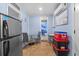 Cozy kitchenette with a table, chairs, refrigerator, and view into bathroom at 14506 Sutter Pl, Tampa, FL 33625