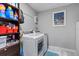 Functional laundry room equipped with modern washer and dryer units, ample storage, and practical design at 14506 Sutter Pl, Tampa, FL 33625
