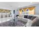 Comfortable living room featuring large windows with attractive curtains, a plush rug, and ample seating at 14506 Sutter Pl, Tampa, FL 33625