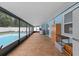 Enclosed outdoor patio with tile flooring, providing a versatile space for dining, lounging, and overlooking the pool at 14506 Sutter Pl, Tampa, FL 33625