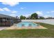 Backyard with a private swimming pool, patio area, and well-maintained lawn at 14506 Sutter Pl, Tampa, FL 33625