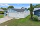 Side exterior view featuring a white fence, well-kept lawn, and light blue accents at 14506 Sutter Pl, Tampa, FL 33625
