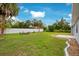 Fenced-in backyard with seating area and patio, perfect for outdoor entertaining at 2706 Flagami Ln, North Port, FL 34286