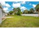 Expansive backyard featuring lush green grass, a manicured lawn, and serene landscaping, perfect for outdoor enjoyment at 2706 Flagami Ln, North Port, FL 34286