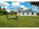 The backyard features a well-maintained lawn and a patio seating area at 2706 Flagami Ln, North Port, FL 34286