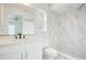 Modern bathroom featuring a sleek vanity, stylish mirror, and a beautifully tiled shower and tub combination at 2706 Flagami Ln, North Port, FL 34286