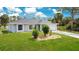 Beautiful single-story home with arched windows, a two-car garage, and well-kept front yard at 2706 Flagami Ln, North Port, FL 34286