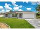 Charming single-story home featuring a well-maintained lawn and an attached two-car garage at 2706 Flagami Ln, North Port, FL 34286