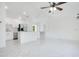 Modern kitchen and open living area featuring stainless steel appliances, white cabinets, and a spacious island at 2706 Flagami Ln, North Port, FL 34286