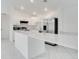 Sleek kitchen featuring stainless steel appliances, white cabinets, quartz countertops, and a breakfast bar at 2706 Flagami Ln, North Port, FL 34286
