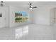 Bright, open living space with large arched windows, tile flooring, and modern ceiling fan at 2706 Flagami Ln, North Port, FL 34286
