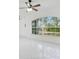 Bright living space featuring large arched window and tile flooring, offering a clean, modern aesthetic at 2706 Flagami Ln, North Port, FL 34286