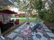 Backyard featuring rock garden, fire pit, patio, furniture and lush landscaping at 663 68Th S Ave, St Petersburg, FL 33705